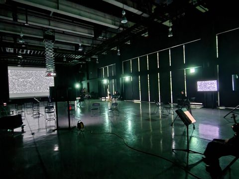 홀 한쪽 벽면의 모니터와 정면 스크린에 같은 영상이 나오고, 악보대와 연주자가 놓인 리허설 장면
